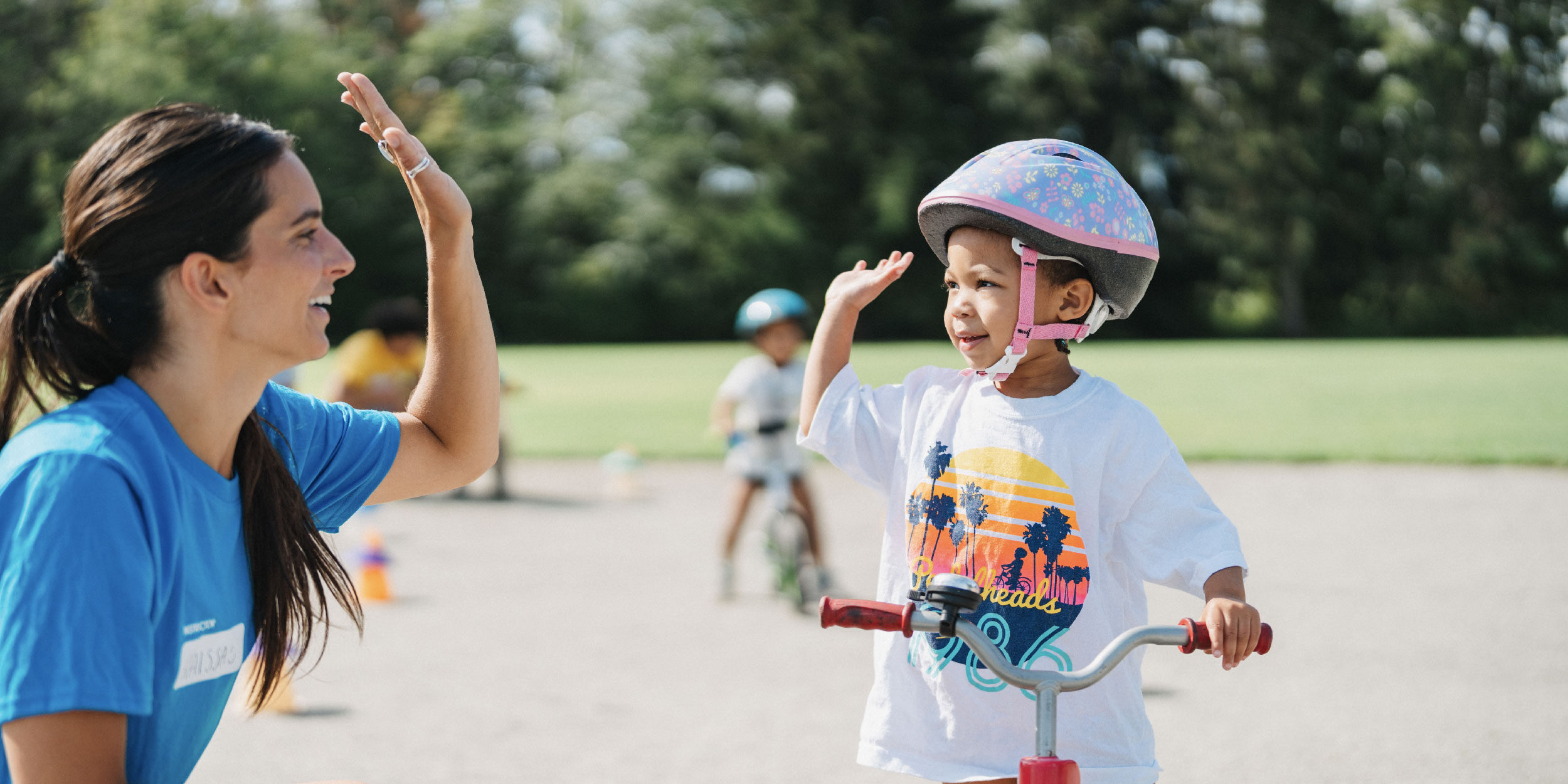 instructor-high-fiving-girl-at-camp